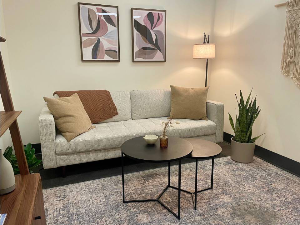 A peaceful seating area with plants and a book